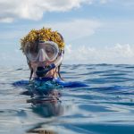 Allison Stillman in the ocean with seaweed on her head