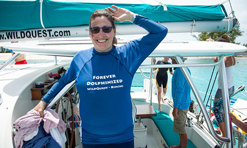 a woman standing on a boat with towels in her hand